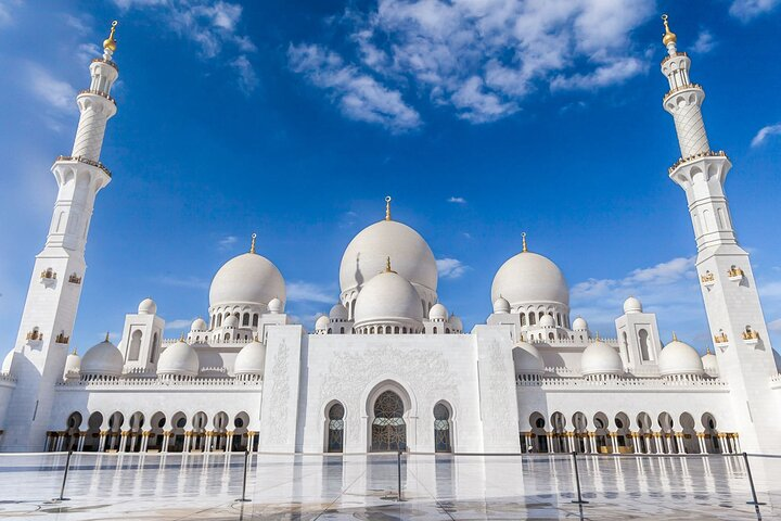 Experience the stunning architecture of the Grand Mosque where intricate designs blend with the serene landscape offering a memorable insight into Abu Dhabi's rich cultural heritage.